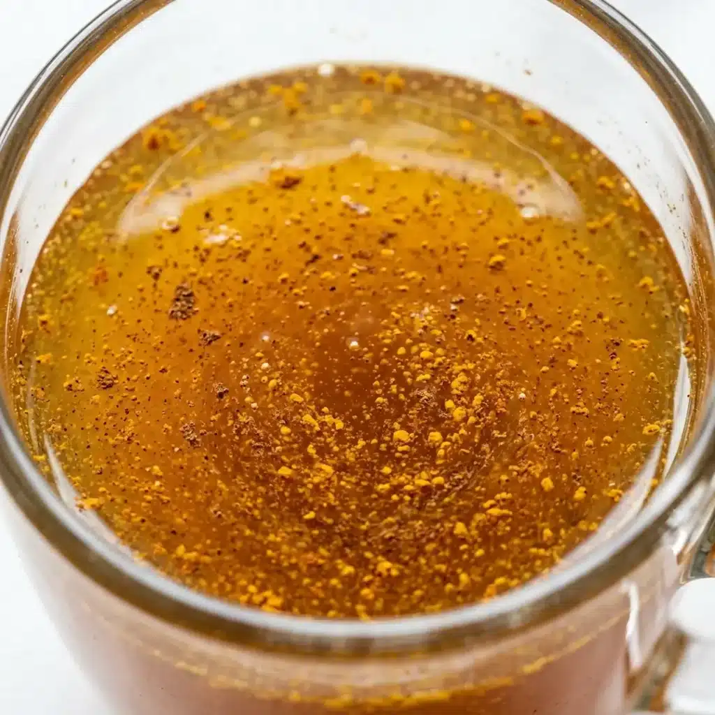Surface Detail of Neuro Honey Blend Macro close-up of the surface of neuro honey blend showing specks of cinnamon and turmeric